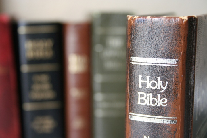 A Bible on a bookshelf.
