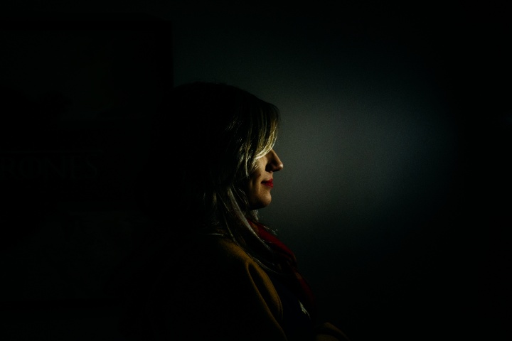 A woman standing in the dark.