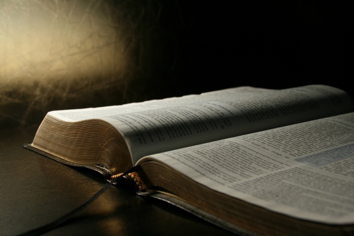 A open Bible laying on a table.