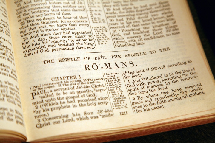 A Bible opened to the book of Romans.