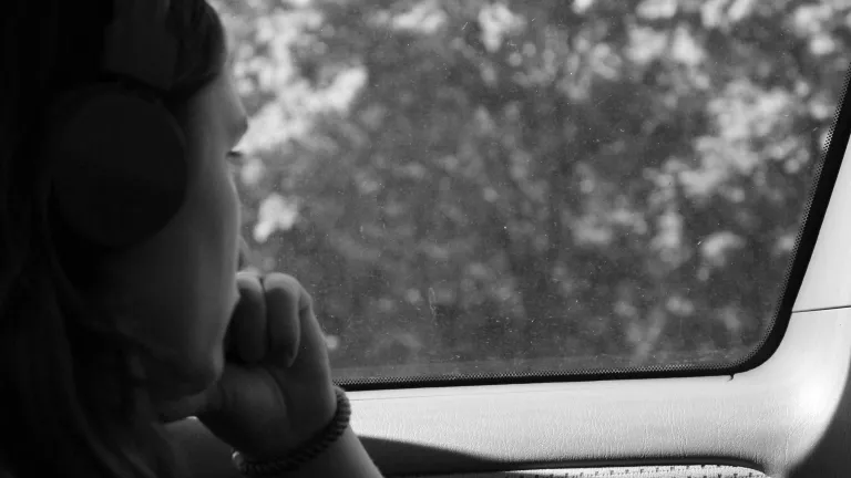a person looking out the window of a car