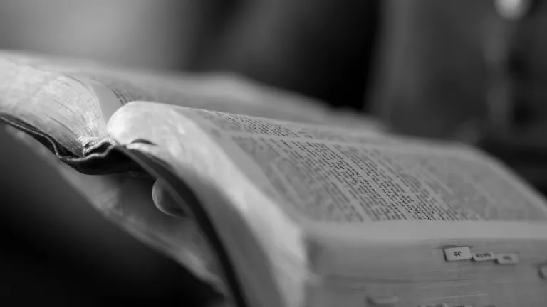 A woman holding an opened Bible.