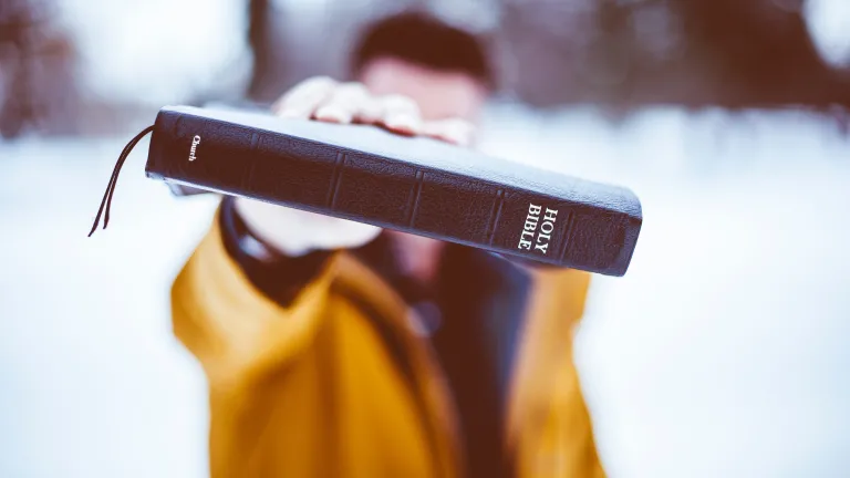 A man holding a Bible.