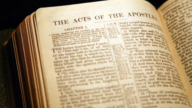 A Bible opened to the book of Acts.