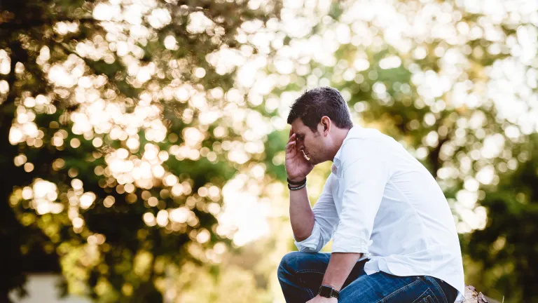 A man sitting and praying.