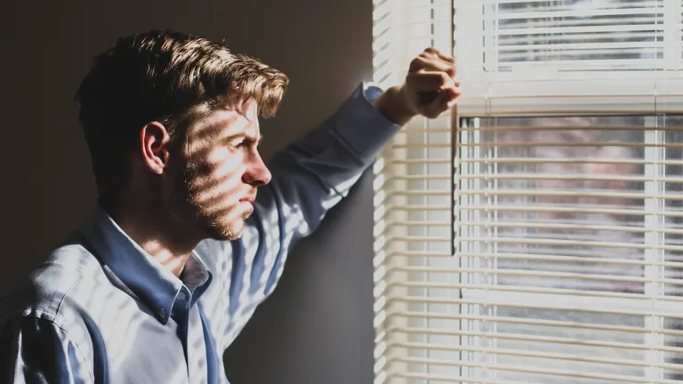 A young man looking out of a window.