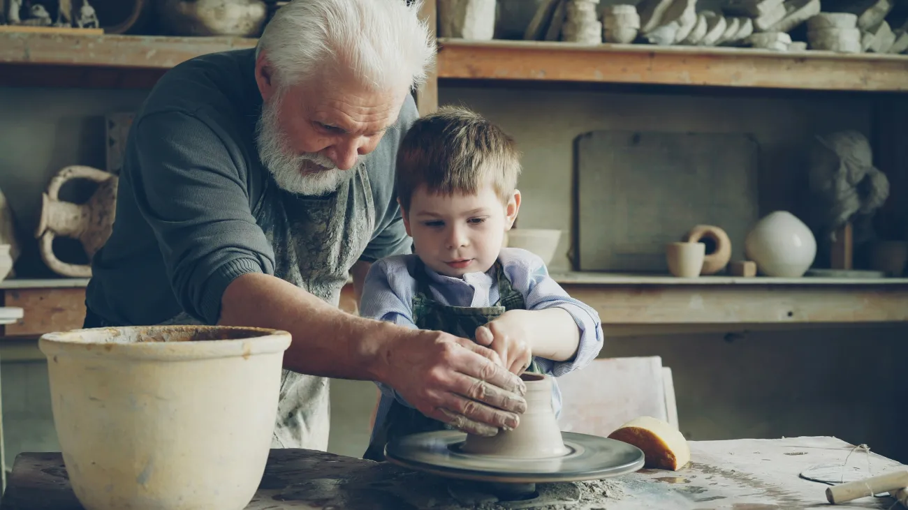 men and child working with clay