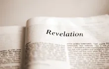 A Bible opened to the book of Revelation.