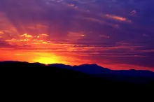 A sunset over a mountain ridge.