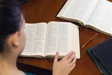 A woman reading the Bible.